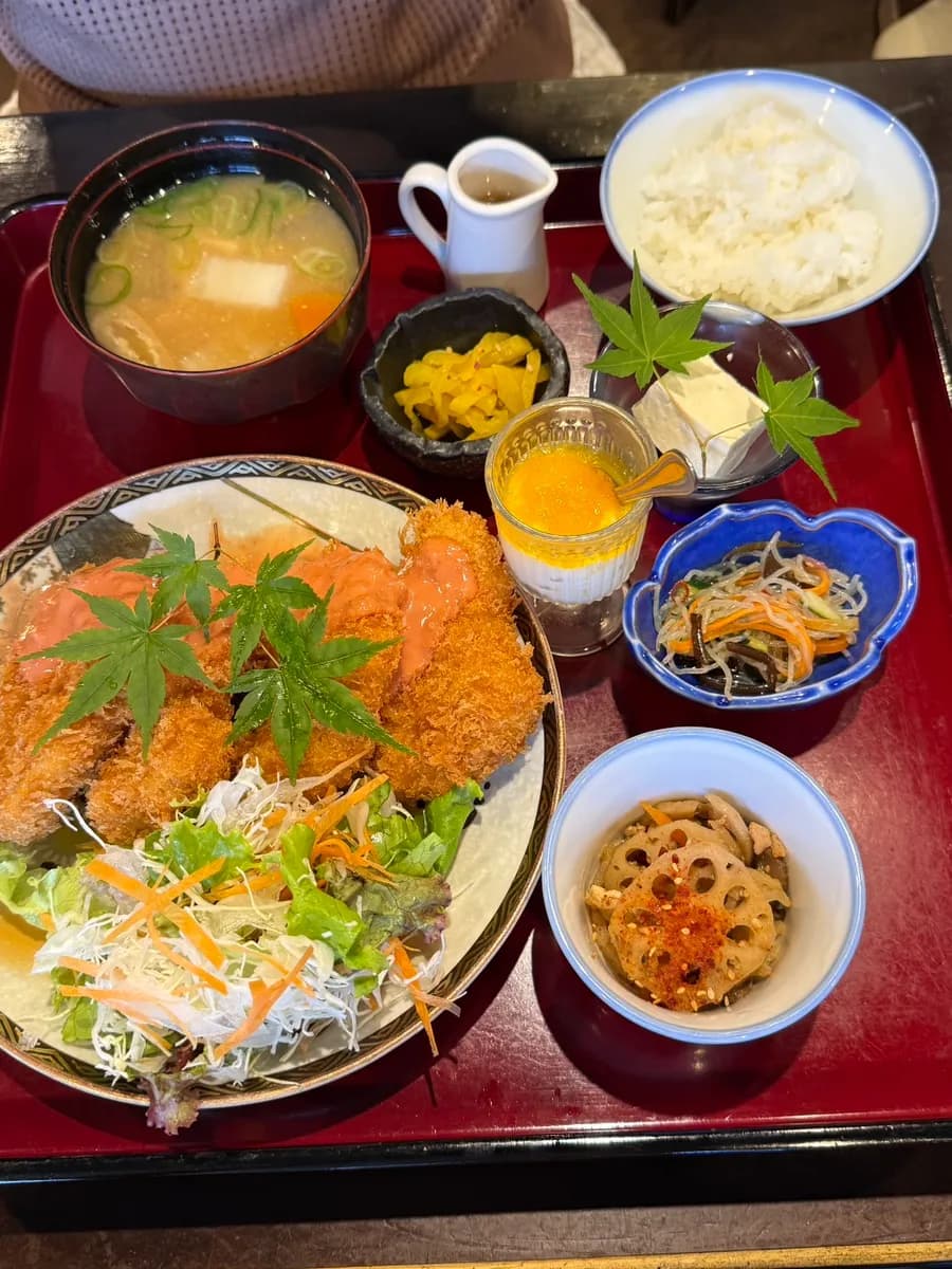 Set meal served with side dishes, soup, sauces and dessert