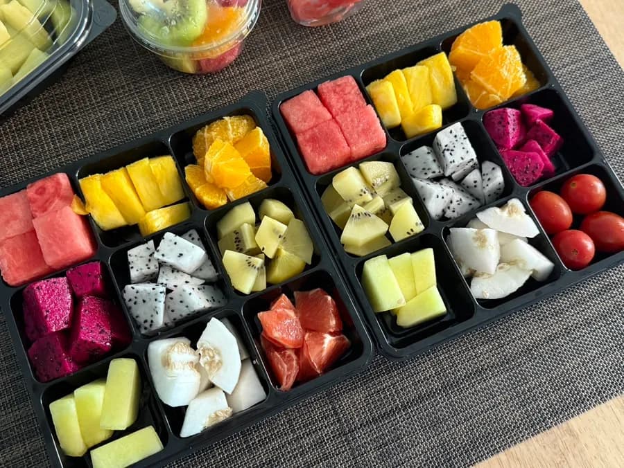 Custom fruit lunchbox with watermelon orange pineapple dragon fruit kiwi melon grapefruit and cherry tomatoes