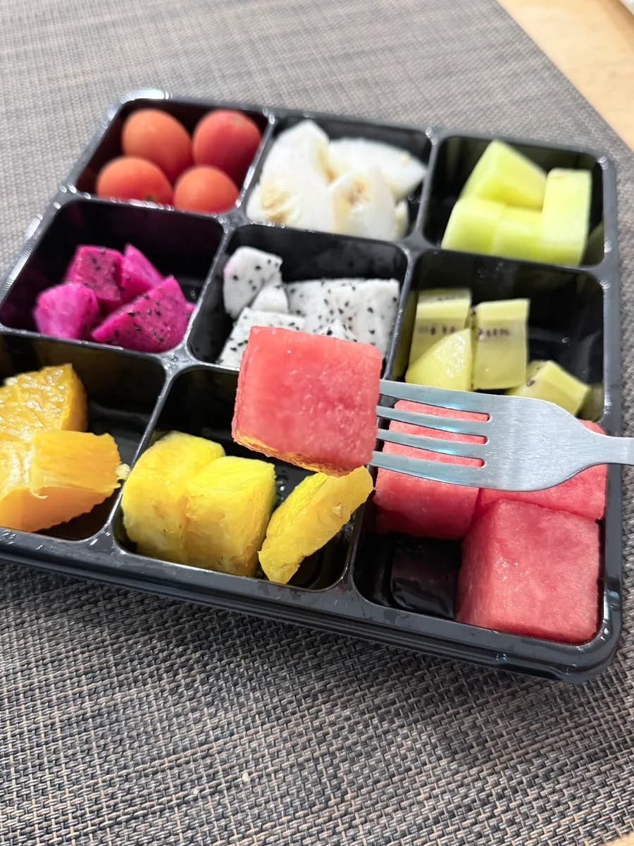 Colorful fresh fruit lunchbox prepared in bite-size pieces