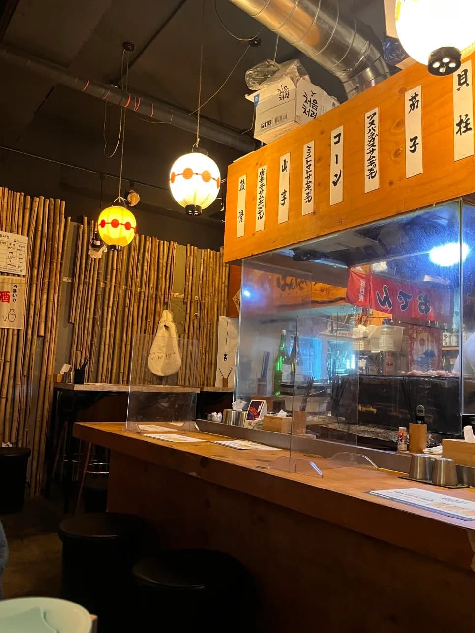 Counter seating and visible skewer grilling area at Banshaku