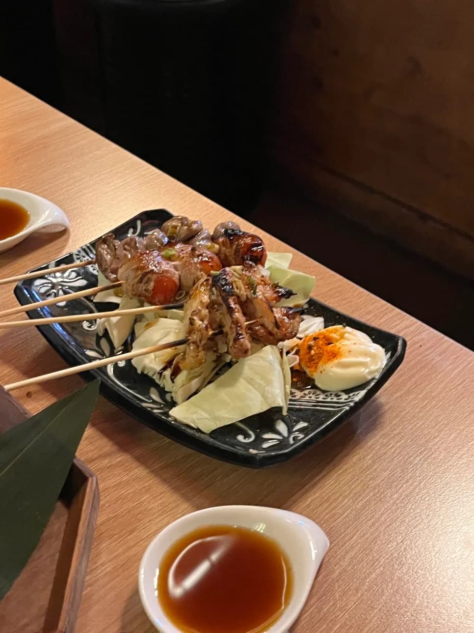 Three kinds of yakitori including bacon tomato roll and heart