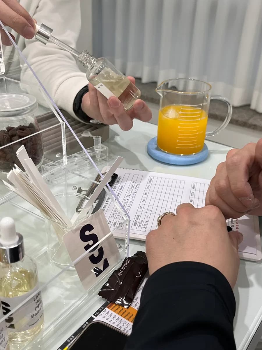 Opening small scent bottles to test preferred fragrances