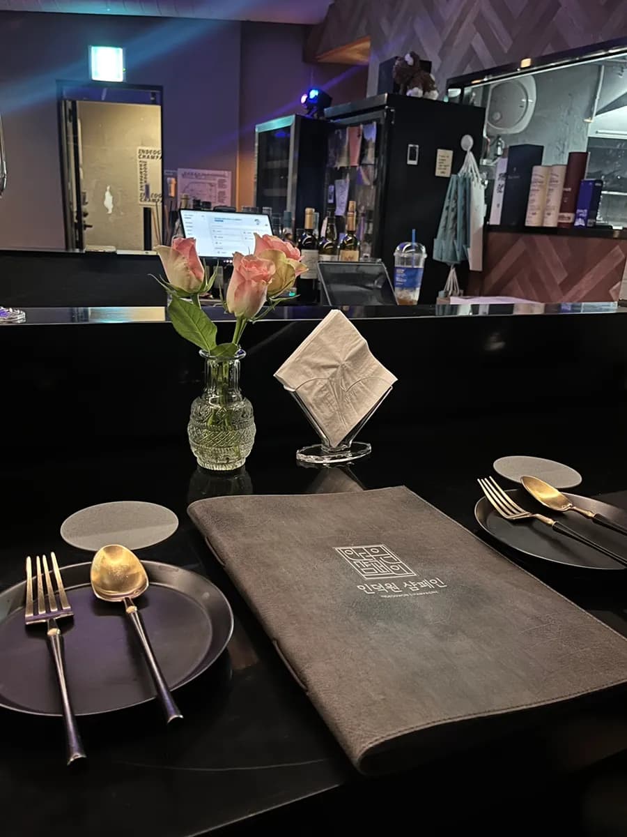 Reserved bar seating setup with fresh flowers at Indeogwon Champagne