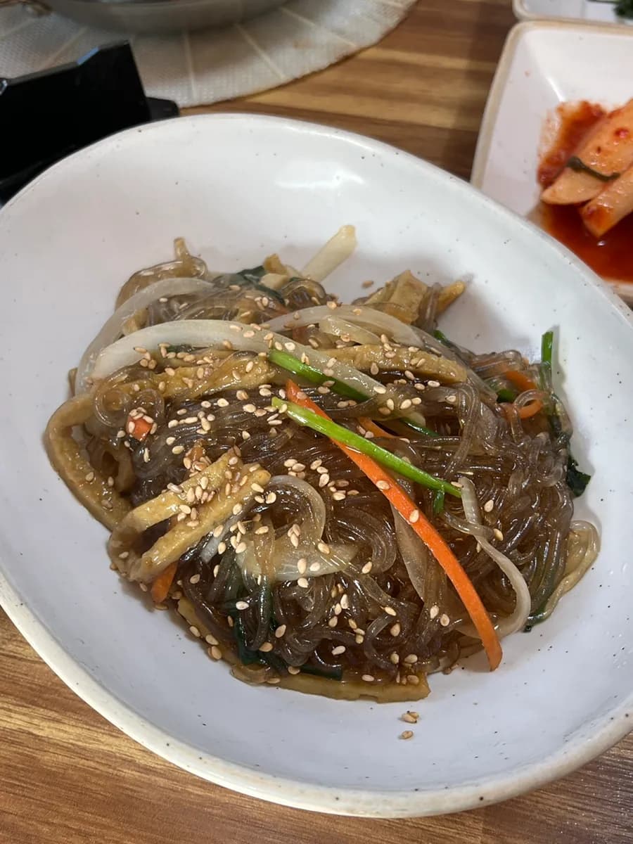 Fresh japchae and grilled fish side dishes