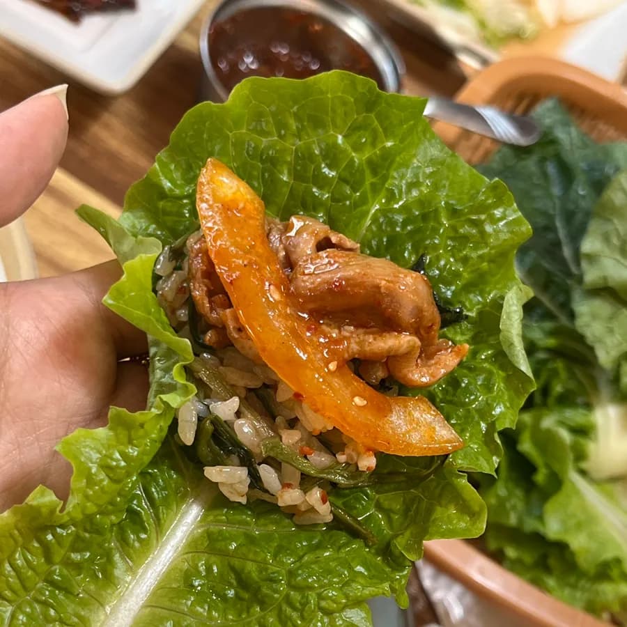 Final bite of duck bulgogi and fresh vegetables
