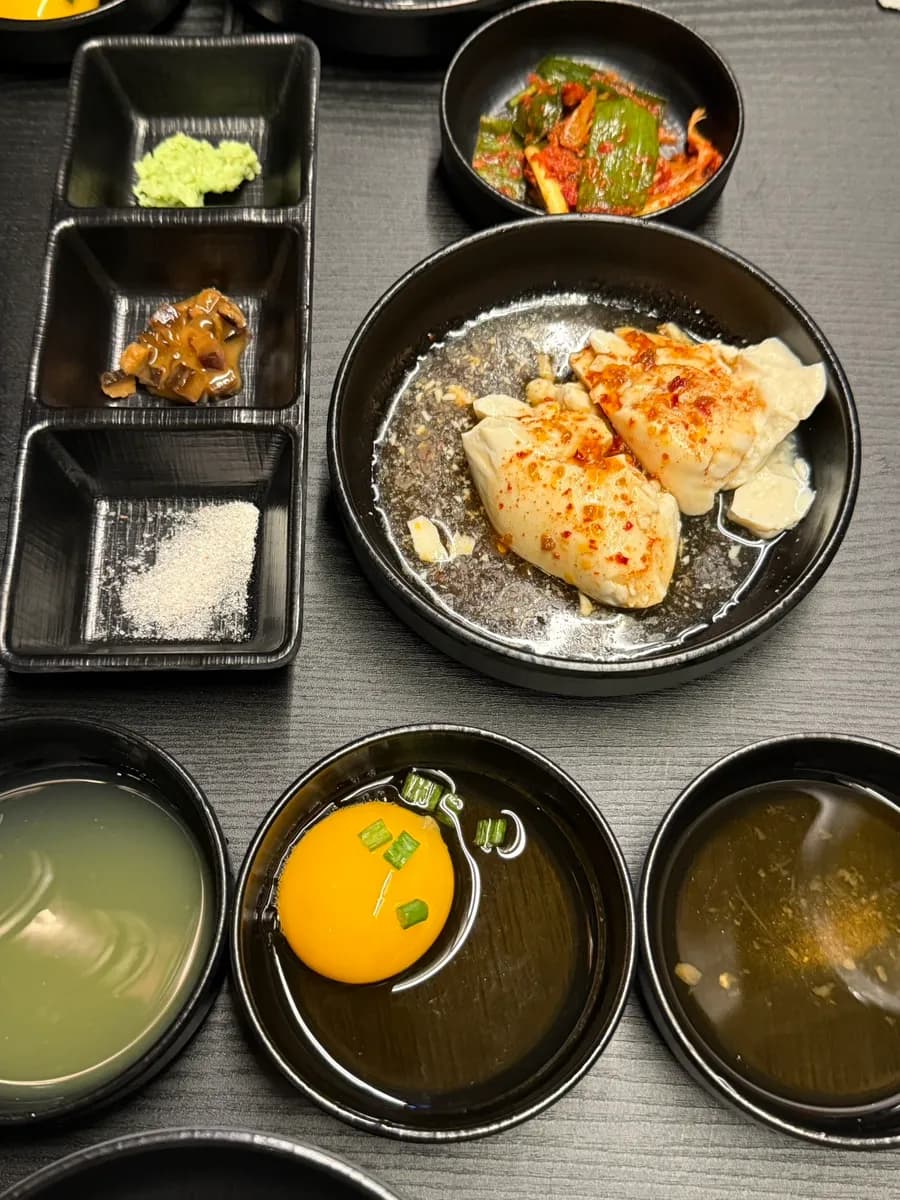 Six sauces served at Yakiniku Yoshi including ponzu, tare, wasabi, salt, and butter sauce