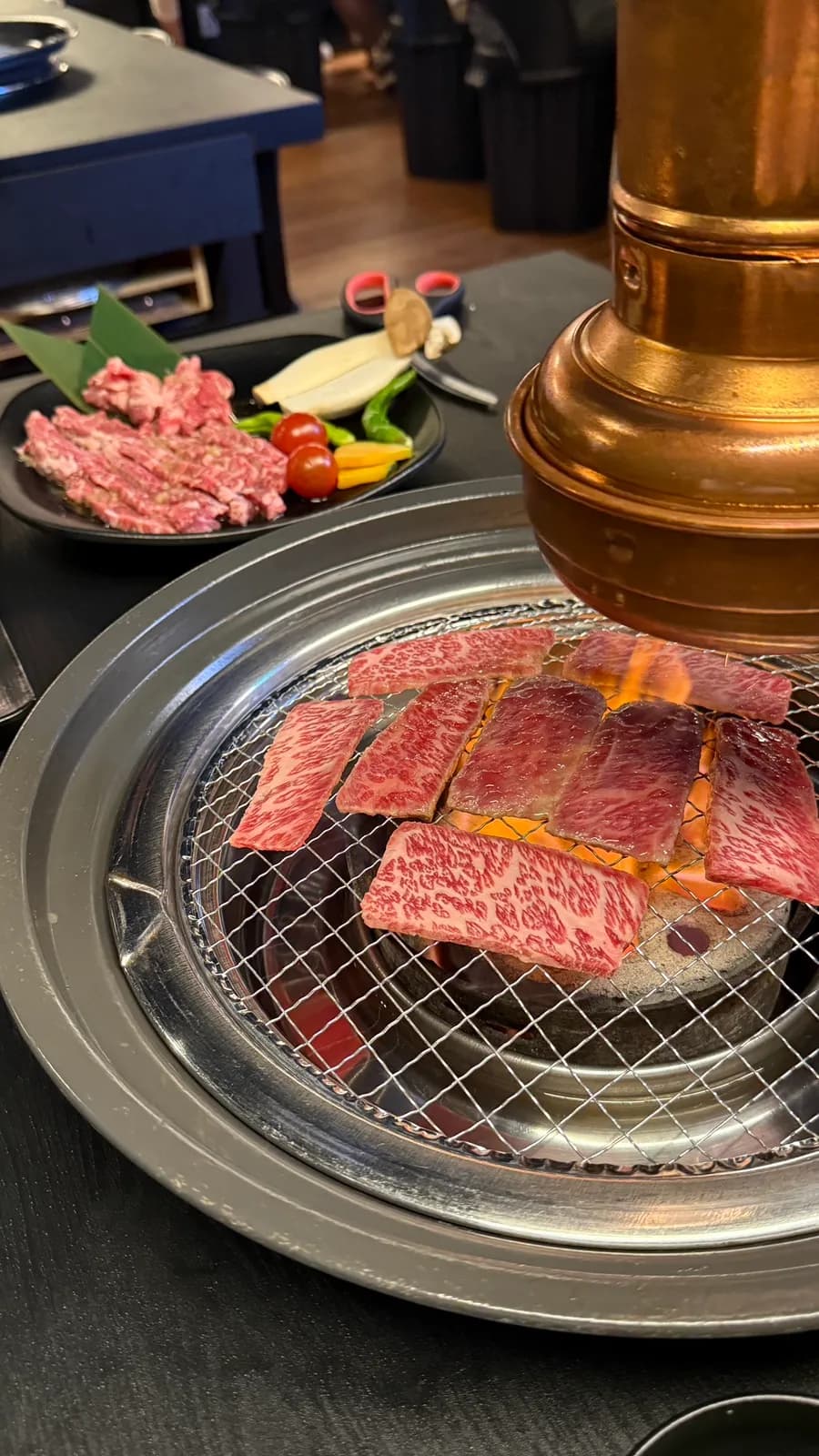 Beef grilling at Yakiniku Yoshi with draft beer