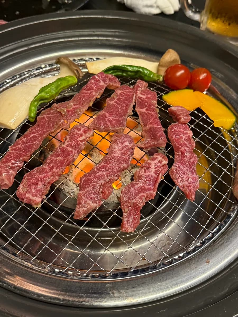 Different grilled beef cuts and vegetables at Yakiniku Yoshi