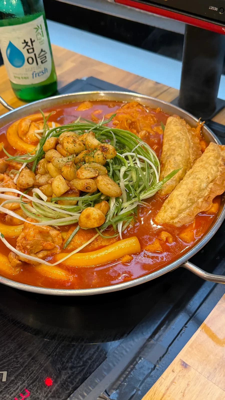 Chicken thigh meat, green onion strips, garlic, and tteokbokki at Cheongnyeon Dabang