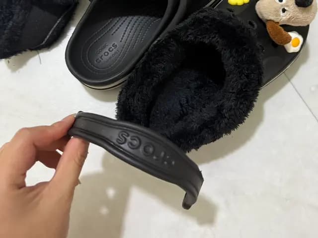 Fleece Crocs liner before installation, with a lint roller tip for loose fibers
