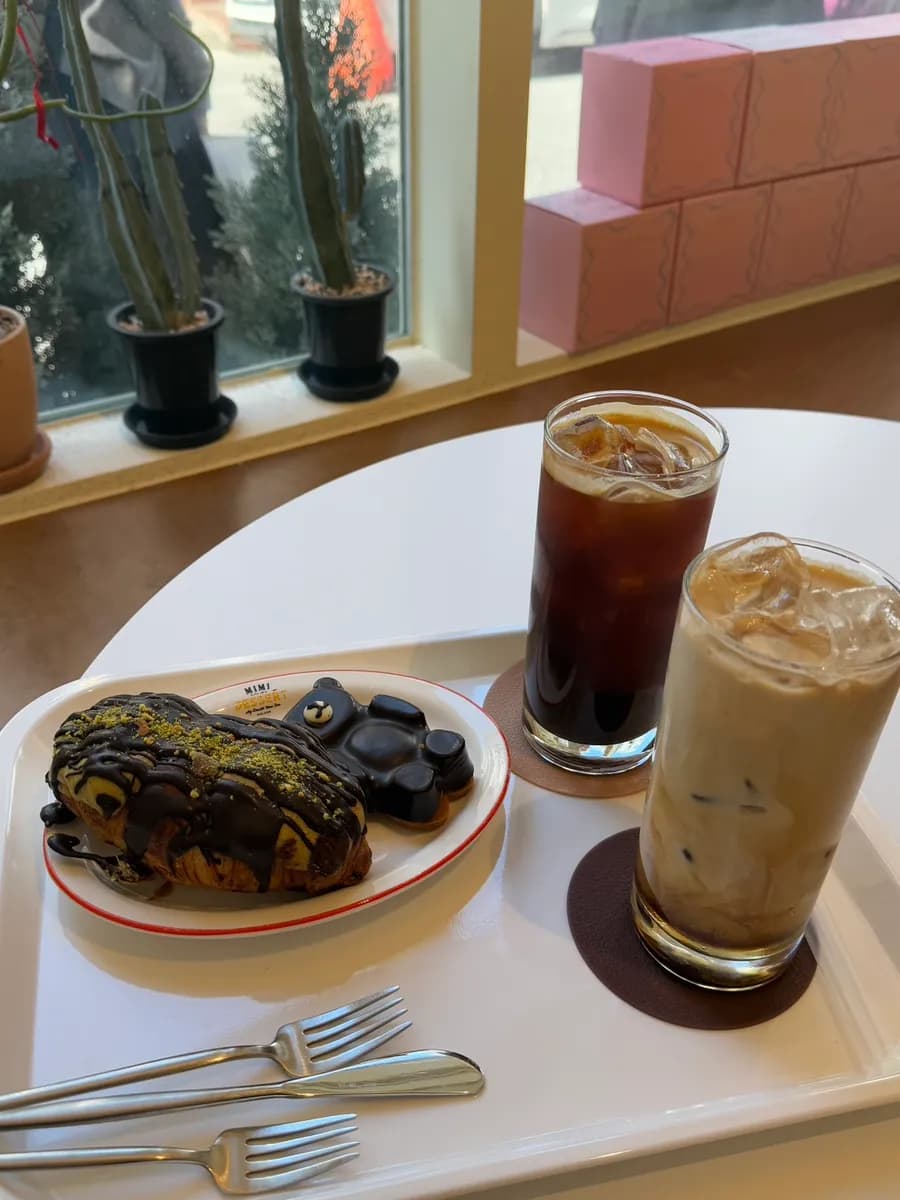 Small dine-in seating area at Mimi Bakery with two to three tables
