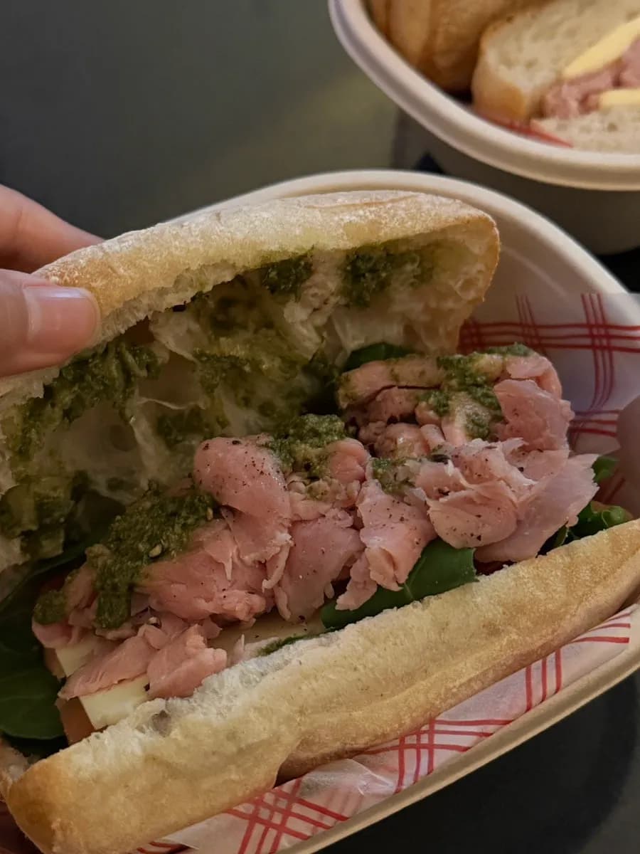 Fresh Jambon ciabatta sandwich with vegetables and basil pesto