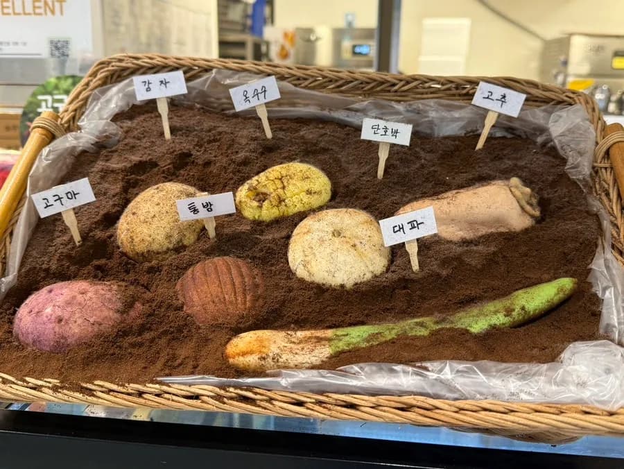 Crop-shaped breads displayed like vegetables at Mas Bakery