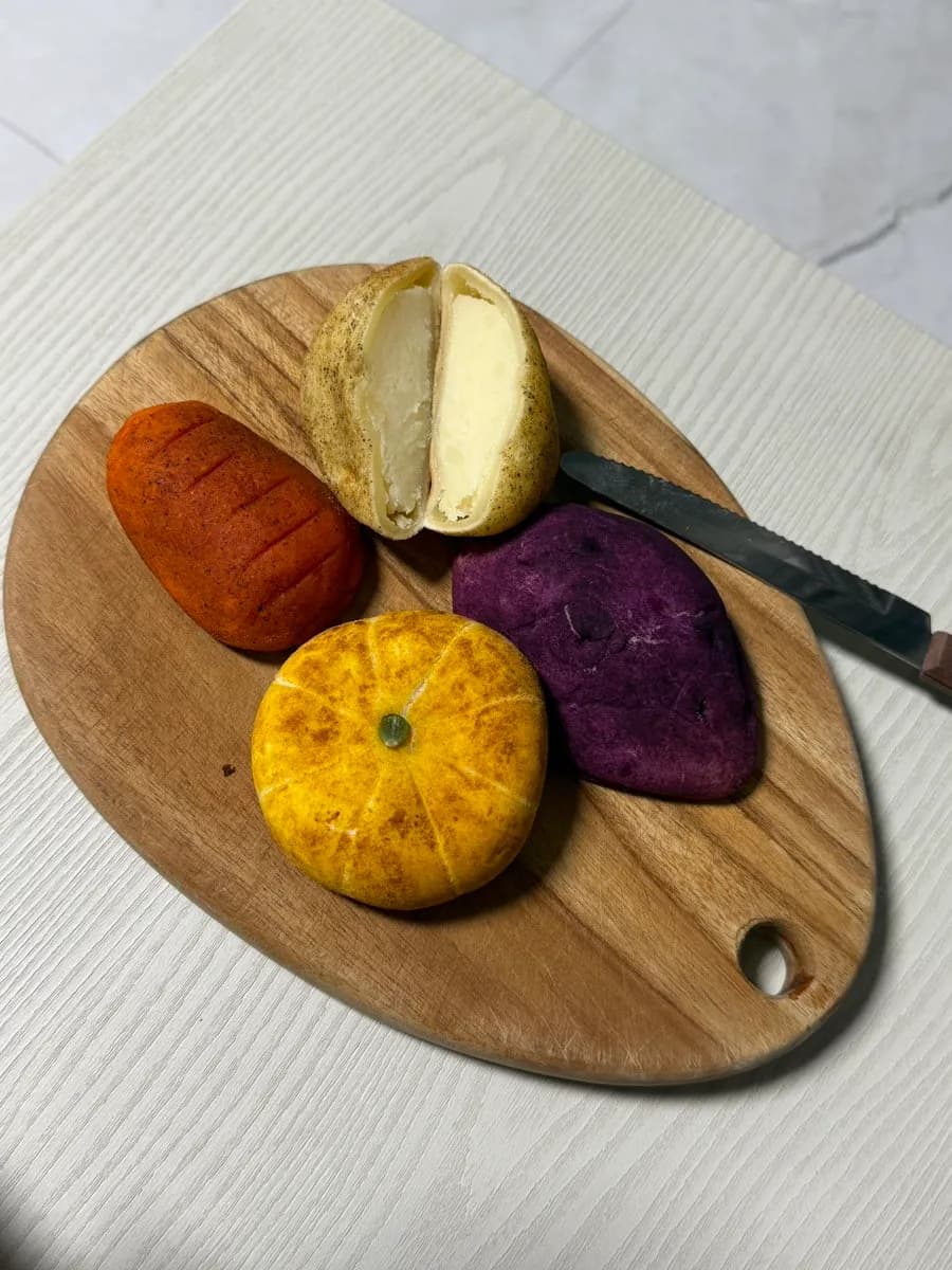 Four soft-looking crop-shaped breads from Mas Bakery