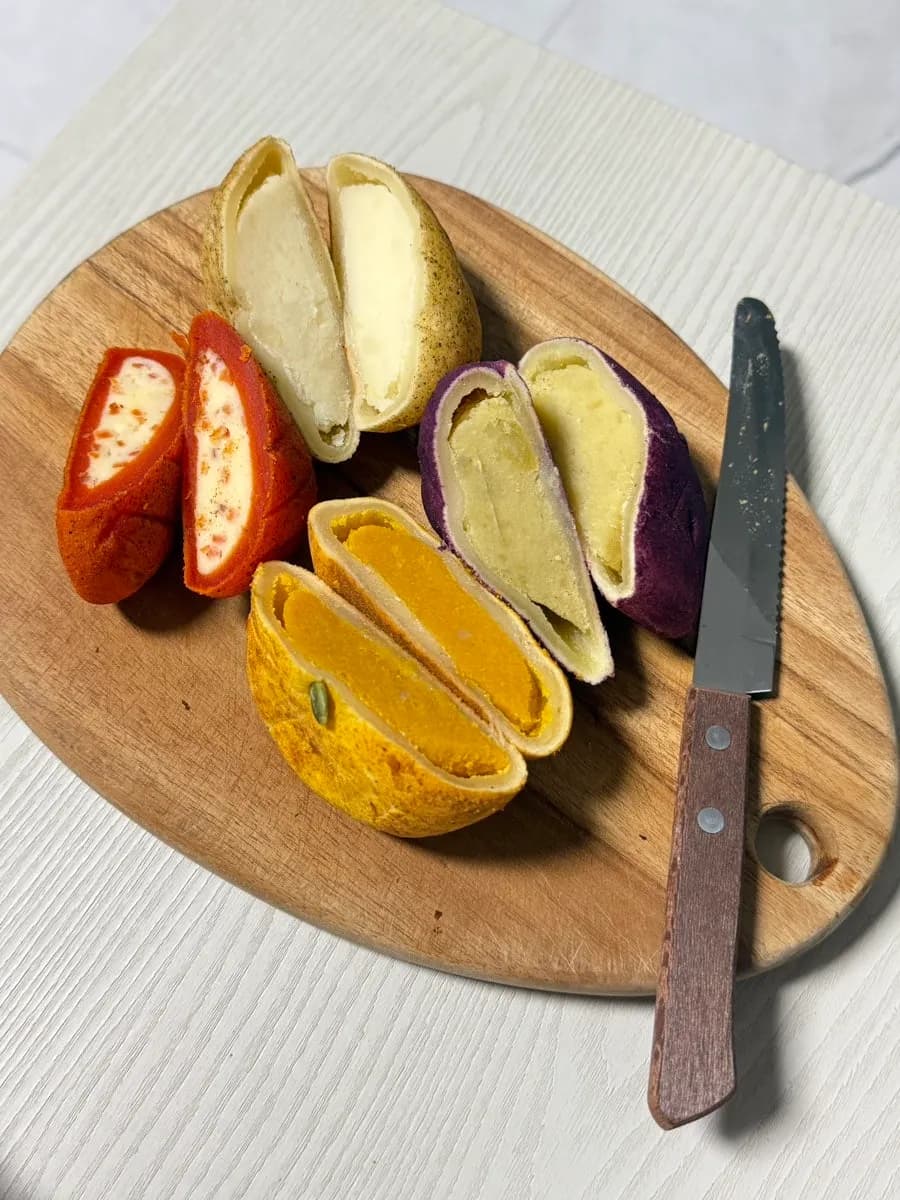 Assorted cut-open crop-shaped breads with filled centers