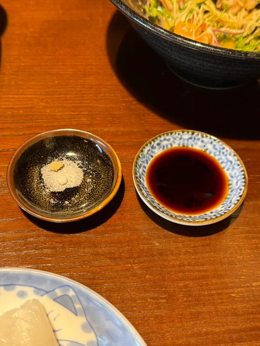 Warm sesame porridge and seafood salad appetizer in the omakase course