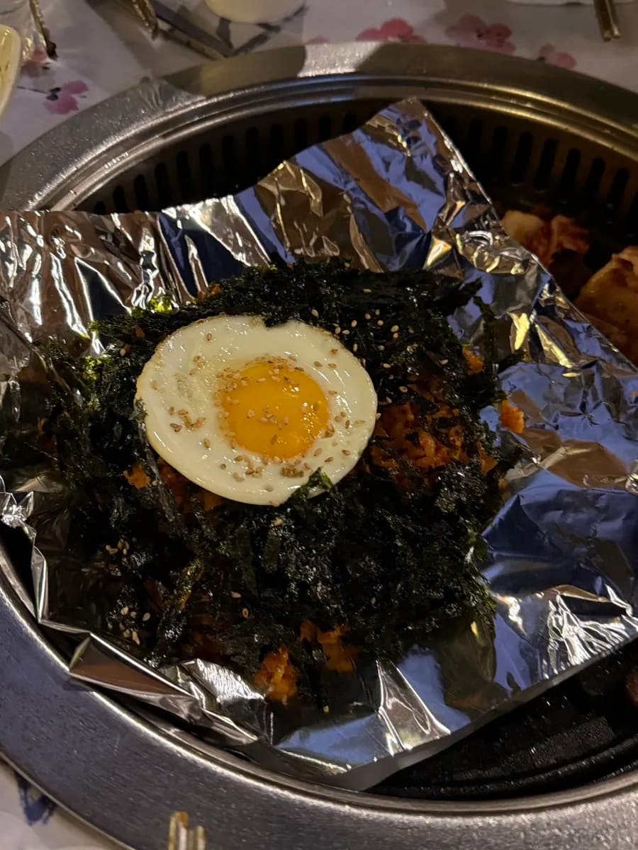 Kimchi fried rice with seaweed flakes and fried egg