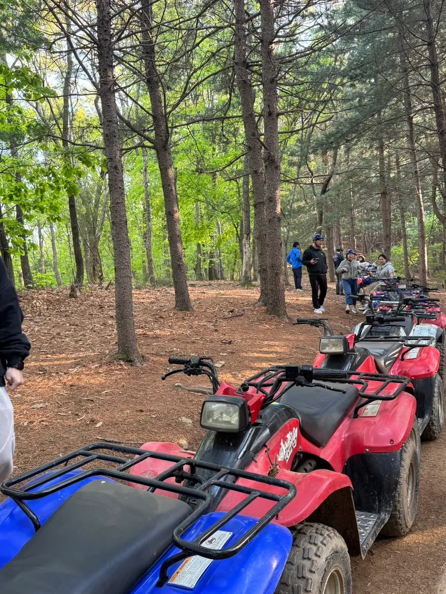 ATV riders waiting safely while instructors manage the road crossing