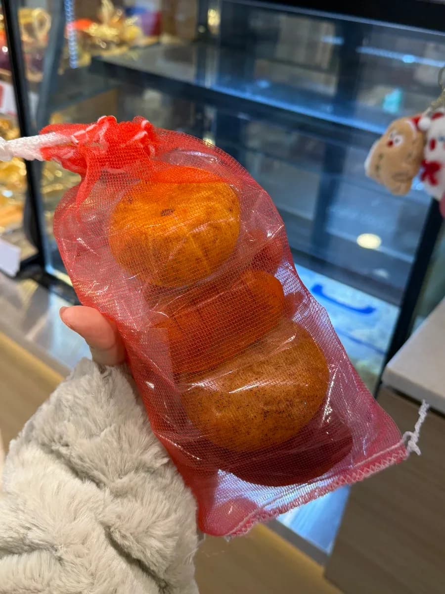 Crop-shaped breads packed in an onion net from Mas Bakery